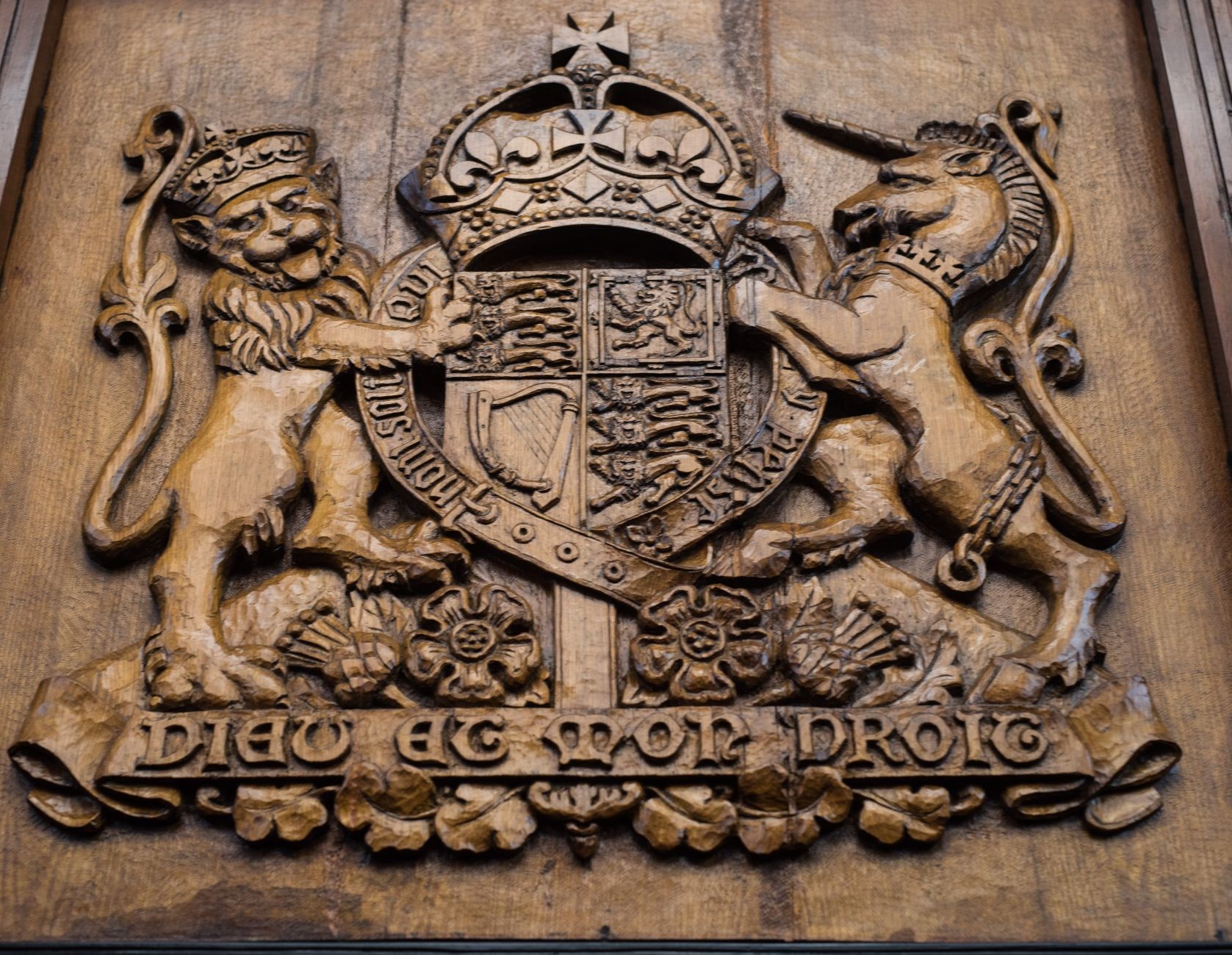 Photo of a wooden carving of the Parliament crest
